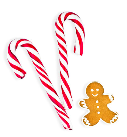 Two candies striped in Christmas colors and gingerbread. isolatedの写真素材