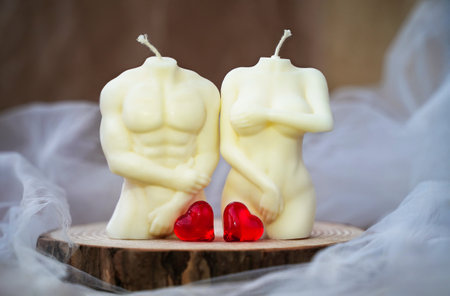 Soy handmade candles and two red hearts. man and woman. Nude figures of male and female bodies. Relationships intimacy concept. Symbol of love. Valentine's Dayの写真素材