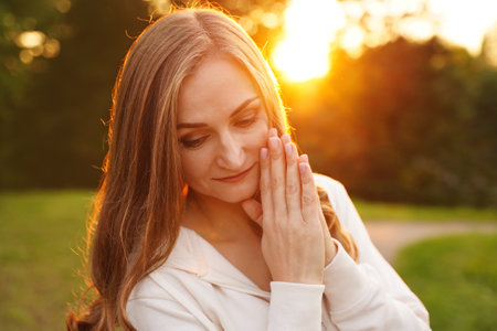Beautiful calm girl outdoors. Summer woman portrait in nature. Concept of self-knowledge. Place for your affirmationの写真素材