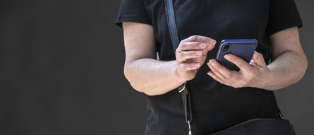 Cropped shot of a person holding a smartphoneの写真素材