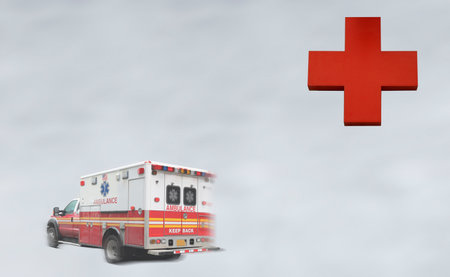 Blurred image of an ambulance and a red cross on a gray backgroundの写真素材