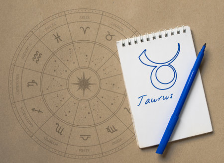 Notepad with pen and drawing of zodiac sign Taurusの写真素材