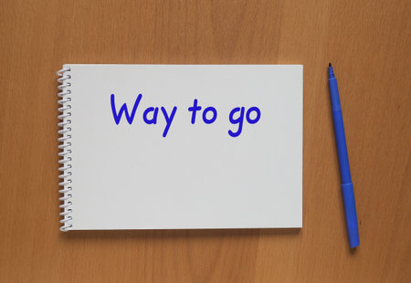 Open notebook with description: Way to go and marker on tableの写真素材