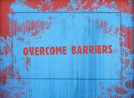 Inscription on a spot of blue paint: overcome barriers