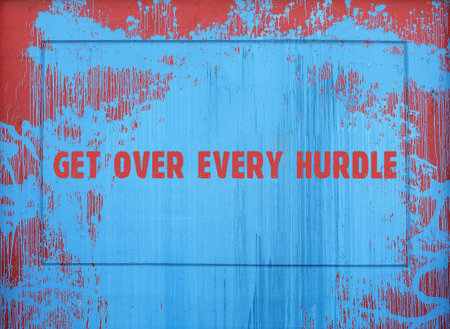 Inscription on a spot of blue paint: get over every hurdle