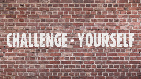Inscription Â«Challenge yourselfÂ» on old brickworkの写真素材