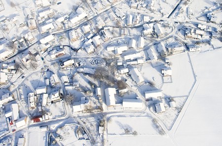 Snow covered winter village in central Europe,air view.の写真素材