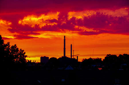 Red Sunset and silhouette of an power plant.の写真素材