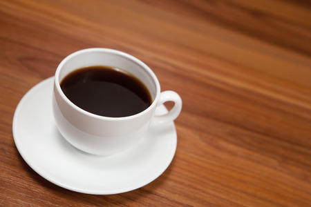 Cup of coffee on dark wood backgroundの写真素材