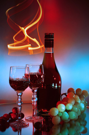 Bottle, glass of cognac (brandy) and bunch of grapesの写真素材