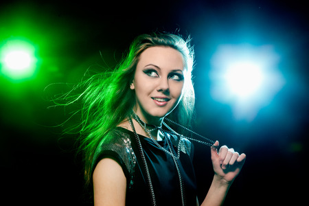 Pretty clubber dancing and looking sideways with smile. Closeup.の写真素材