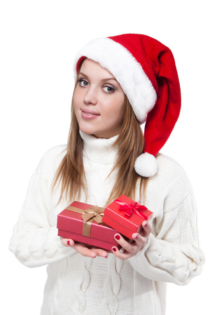 Young beautiful woman wearing a santa hat smiling with giftsの写真素材