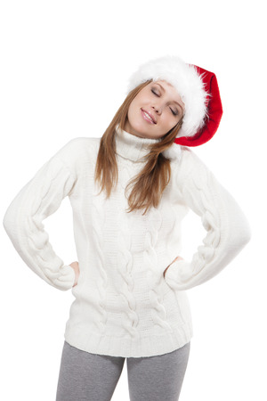 Thoughtful beautiful young woman in a Santa hat isolated on white backgroundの写真素材