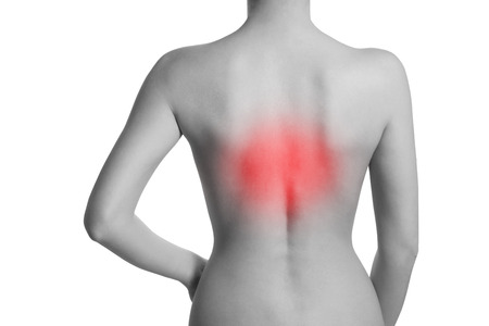Woman suffering from backache. The chest spine is highlighted by red colour.の写真素材