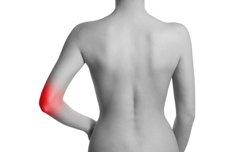 Woman having pain in her elbow. Elbow is highlighted by red colour.の写真素材