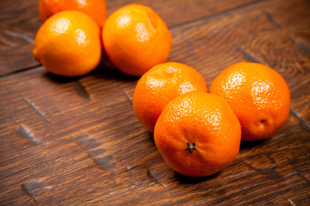 Tangerines on old wooden tableの写真素材