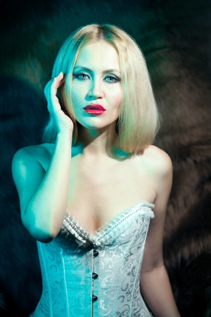Beautiful blonde woman in white corsetの写真素材