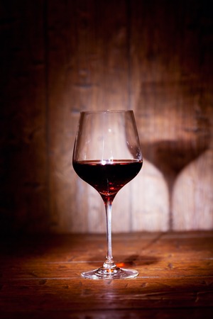 Wine glass on old wooden backgroundの写真素材