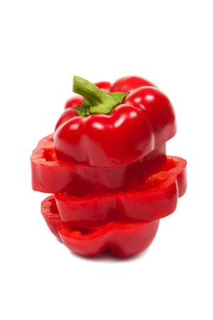Red pepper slices isolated on white backgroundの写真素材