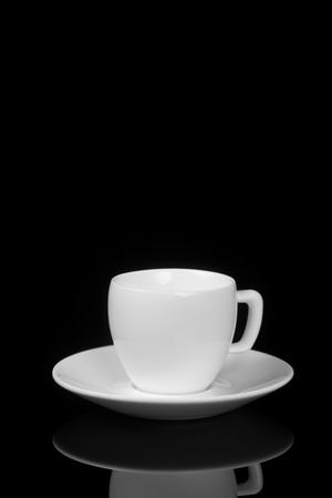 White cup on glossy black background with reflection. With place for text.の写真素材