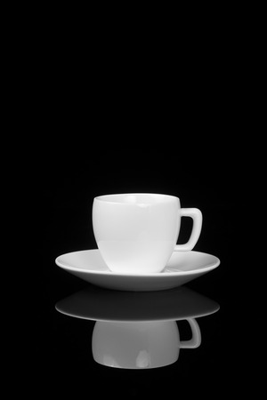 White cup on glossy black background with reflection. With place for text.の写真素材