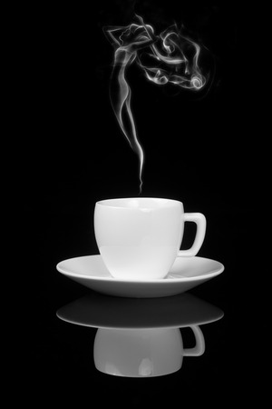 Cup of coffee with woman-shaped smoke on black background with reflectionの写真素材