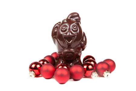 Chocolate Rooster and christmas red balls isolated on a white background. New year 2017.の写真素材