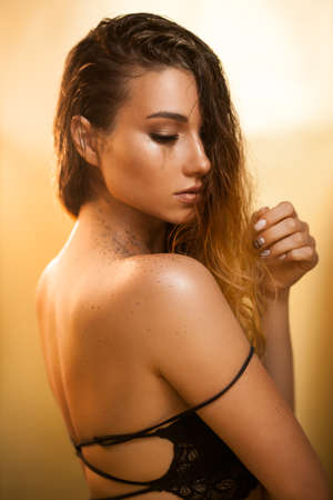 Beautiful young woman with wet hair and face.の写真素材