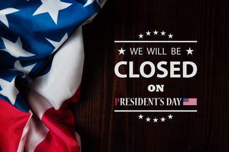 President's Day Background Design. American flag on a wooden table with a message. We will be Closed on President's Day.の写真素材