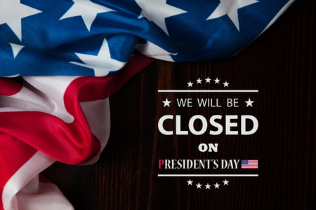 President's Day Background Design. American flag on a wooden table with a message. We will be Closed...