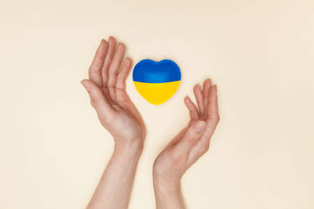 Heart with print the national flag of ukraine in female hands. Flat lay.の写真素材