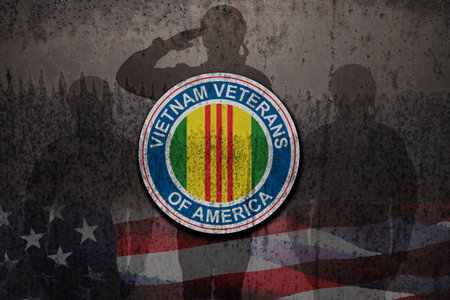 Silhouettes of soldiers saluting and Symbol of the Vietnam Veterans of America on rusty iron background with USA flag. Vietnam Veterans Day. Grunge style.の写真素材