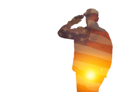 Silhouette of soldier with print of sunset and USA flag saluting isolated on white background. Greeting card for Veterans Day, Memorial Day, Independence Day. America celebration.の写真素材