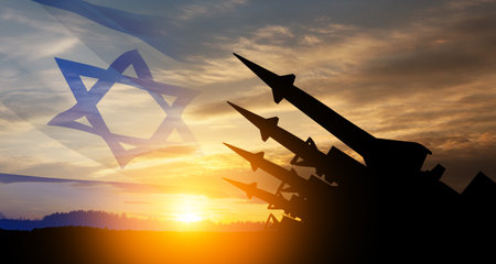 The missiles are aimed at the sky at sunset with Israel flag. Nuclear bomb, chemical weapons, missile defense, a system of salvo fire.の写真素材