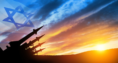 The missiles are aimed at the sky at sunset with Israel flag. Nuclear bomb, chemical weapons, missile defense, a system of salvo fire.の写真素材