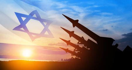 The missiles are aimed at the sky at sunset with Israel flag. Nuclear bomb, chemical weapons, missile defense, a system of salvo fire.の写真素材