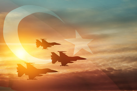 Aircraft silhouettes on background of sunset with a transparent Turkey flag. Turkish Air Force aerobatic demonstration. Air Force Day. Turkish Air Force Foundation Day.の写真素材