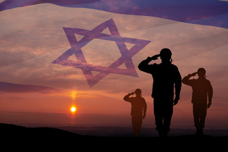 Silhouette of soldiers saluting against the sunrise in the desert and Israel flag. Concept - armed forces of Israel.の写真素材