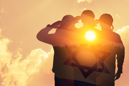 Double exposure of Silhouettes of a soliders and the sunset or the sunrise against Israel flag. Concept - armed forces of Israel.の写真素材