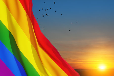 Waving LGBT pride flag on sunset sky with flying birds, rainbow flag background. Multicolored peace flag movement. Original colors symbol.の写真素材