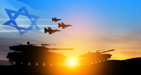 Silhouettes of army tanks and fight planes on background of sunset with a transparent waving Israel flag. Military machinery. Independence day.の写真素材