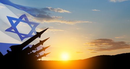 The missiles are aimed at the sky at sunset with Israel flag. Nuclear bomb, chemical weapons, missile defense, a system of salvo fire.の写真素材