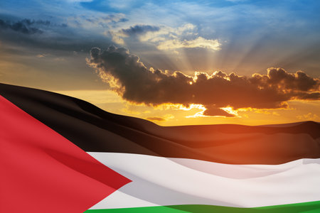 Palestine flag on background of sunset sky. Patriotic concept. Banner with place for text.の写真素材