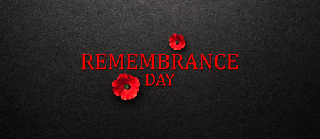 Remembrance Day inscription with Poppy flower on black textured background. Decorative flower for Remembrance Day. Memorial Day. Veterans day.の写真素材