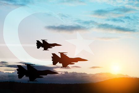 Aircraft silhouettes on background of sunset with a transparent Turkey flag. Turkish Air Force Foundation Day.の写真素材