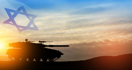 Silhouette of army tank at sunset sky background with Israel flag.の写真素材