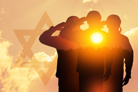 Double exposure of silhouette of a solider and the sunset or the sunrise against sky with silhouette of star of David.の写真素材