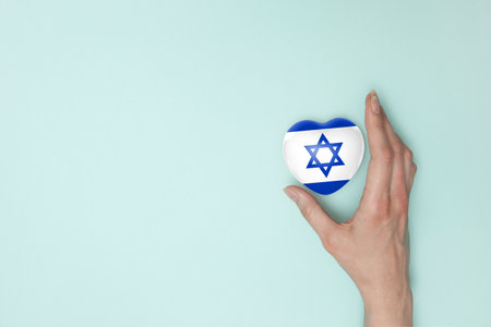 Heart with print of Israel flag in female hands. Flat lay.の写真素材