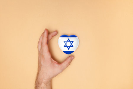 Heart with print of Israel flag in male hands. Flat lay.の写真素材
