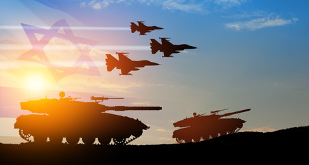 Silhouettes of army tanks and fight planes on background of sunset with a transparent waving Israel flag. Military machinery. Independence day.の写真素材